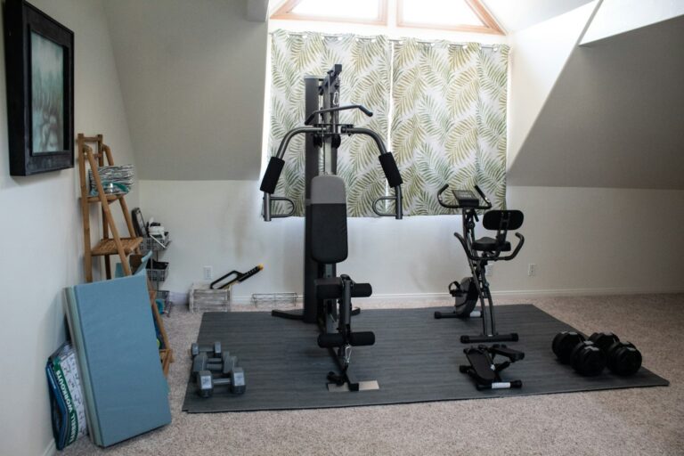 A weight machine and exercise bike in a home gym