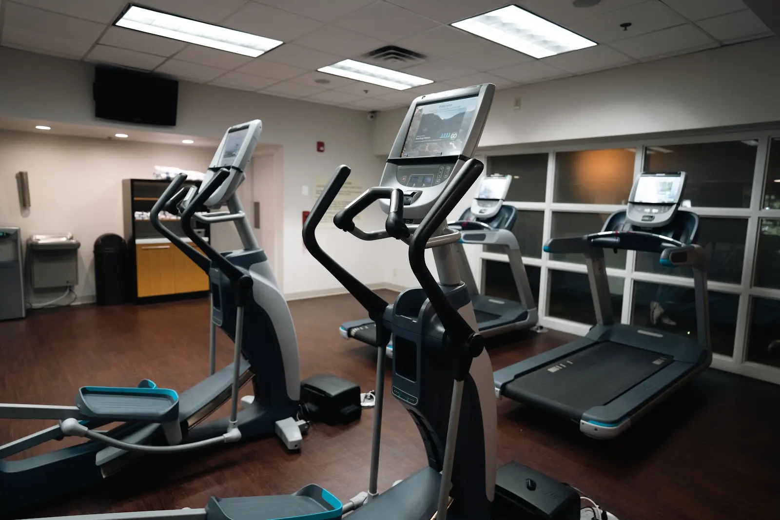 A gym with two elliptical machines and two treadmills. These machines will eventually require maintenance. Fitness Machine Technicians provides trusted service to hundreds of gyms and home fitness centers across the country.